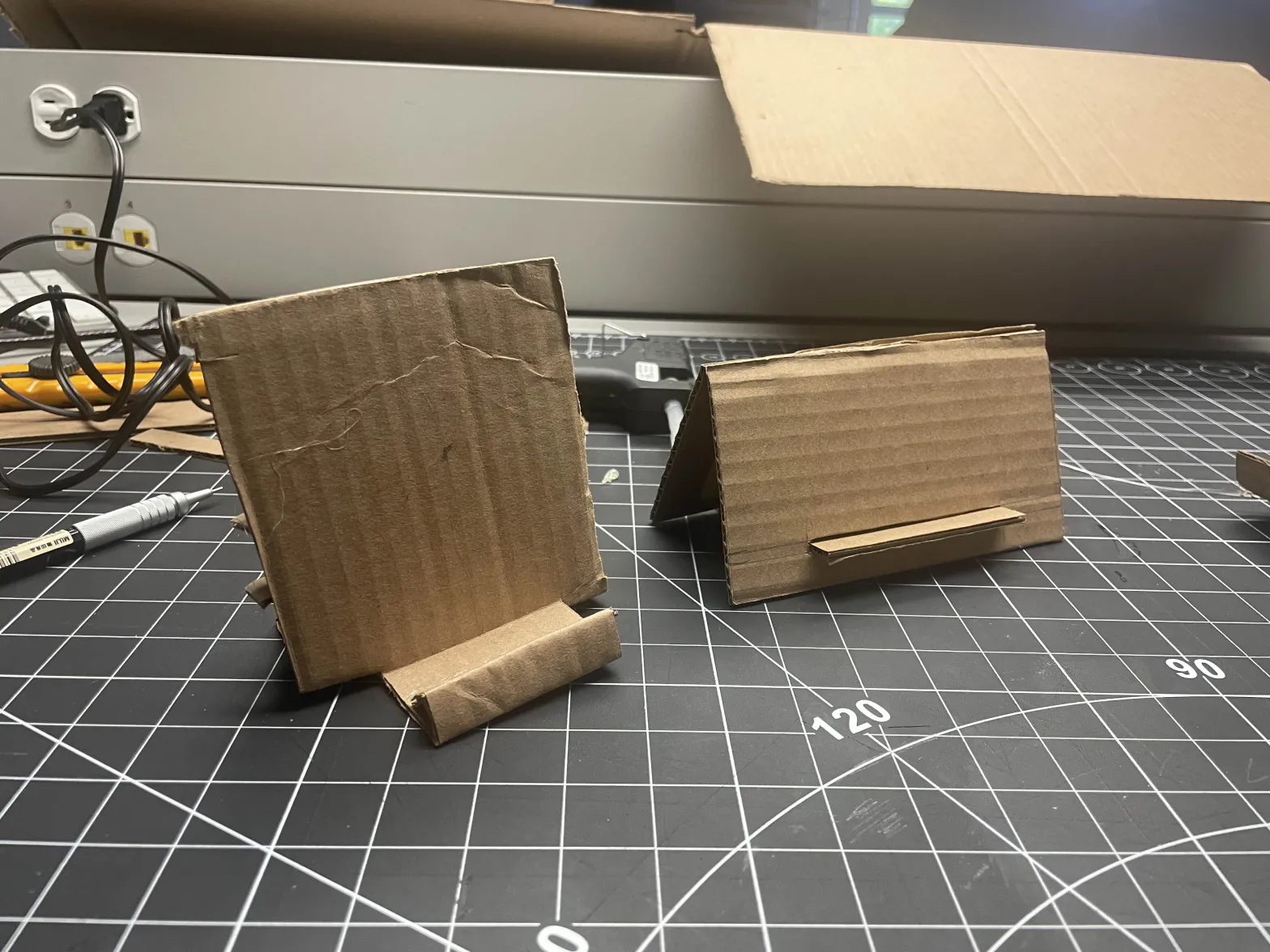 Step #2 of the activity where we iterated based off of Maker Brain's tutorial (the phone stand on the right is the original)